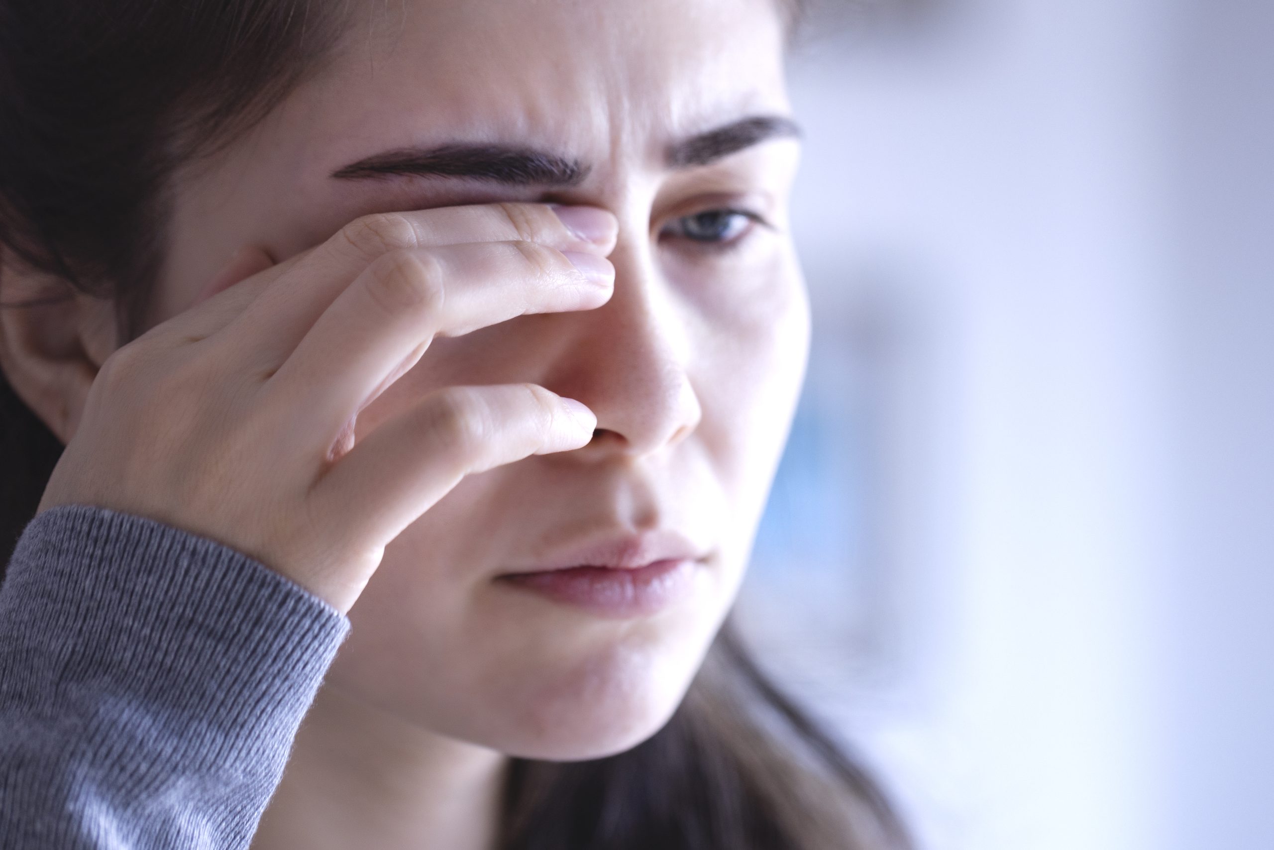 Woman rubbing her irritated eyes