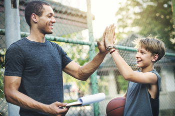 Coach high-fiving a child