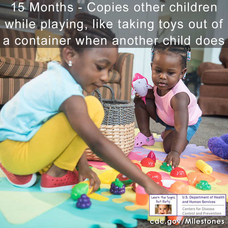 Copies other children while playing, like taking toys out of a container when another child does image 1