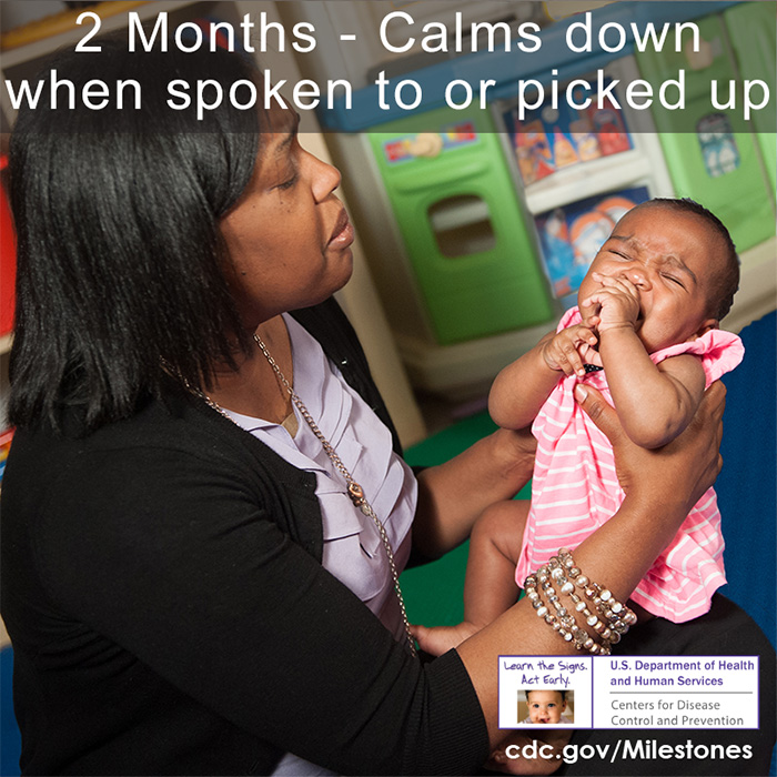Calms down when spoken to or picked up - A baby is upset and her care giver is picking her up to try to calm her down.