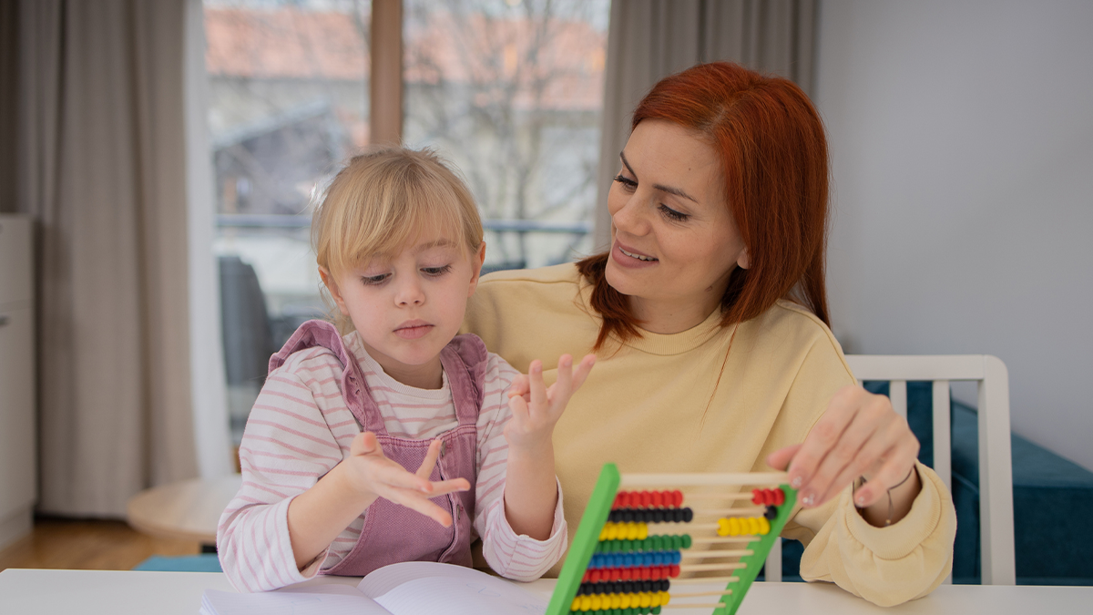 A mother working together with daughter on an activity.