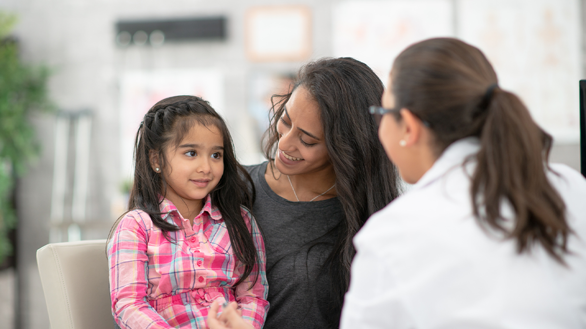 Mother and daughter talking with a doctor about ADHD.