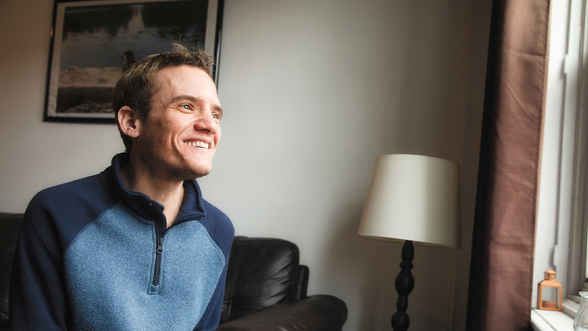 Young adult male with a disability smiling