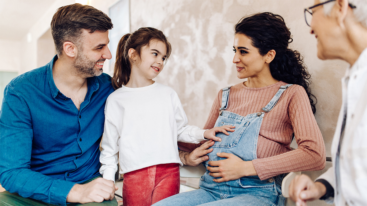 Pregnant mom with family talking to doctor Pregnant mom with family talking to doctor
