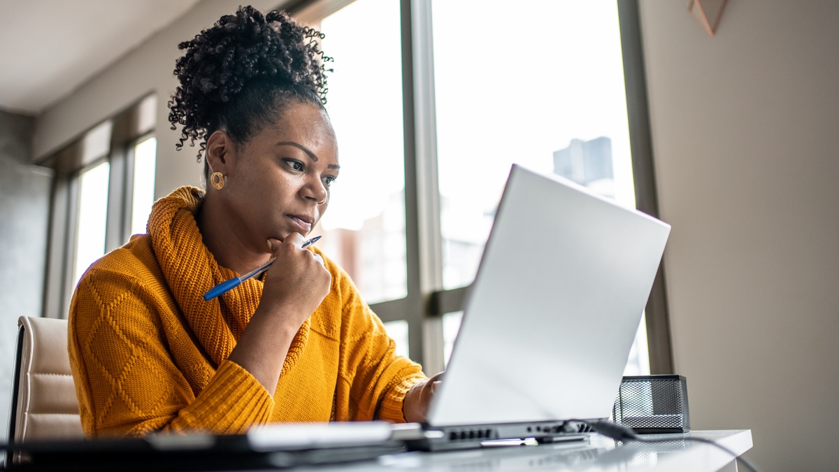 woman doing research on a laptop computer