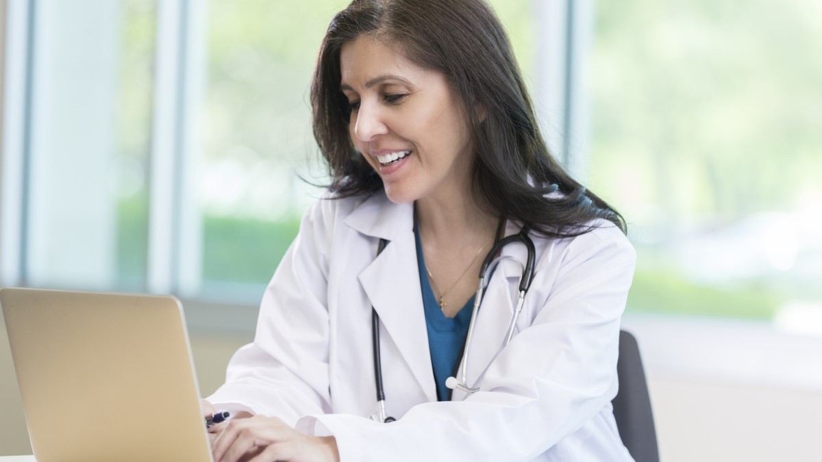 a doctor using a laptop