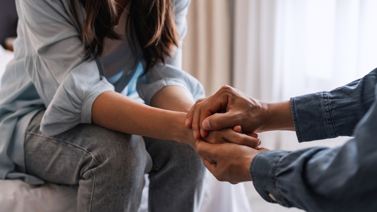 Two people holding hands