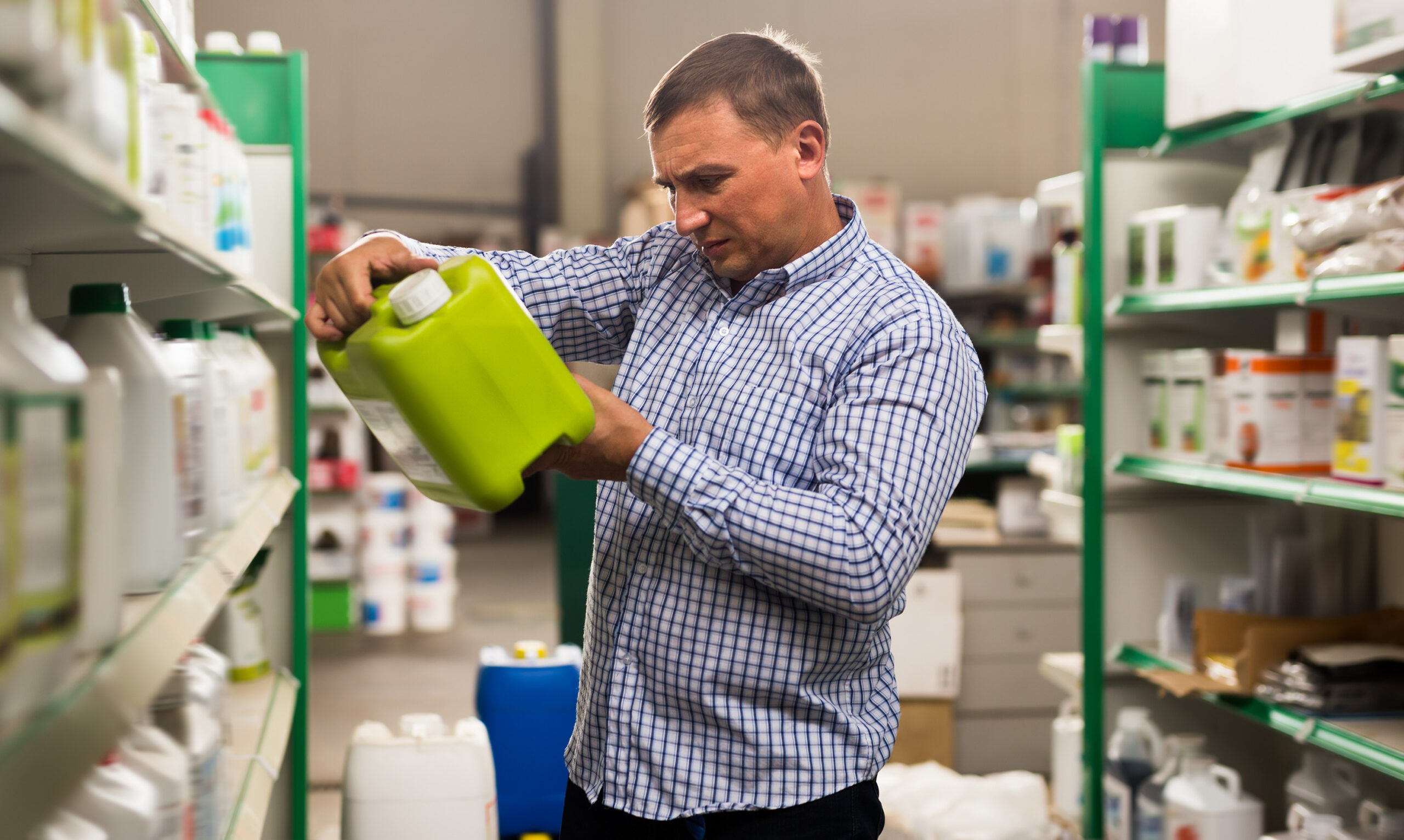 Man buying liquid fertilizer for gardening