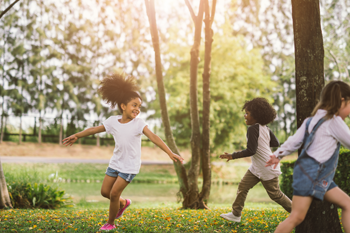 Children running around in the grass