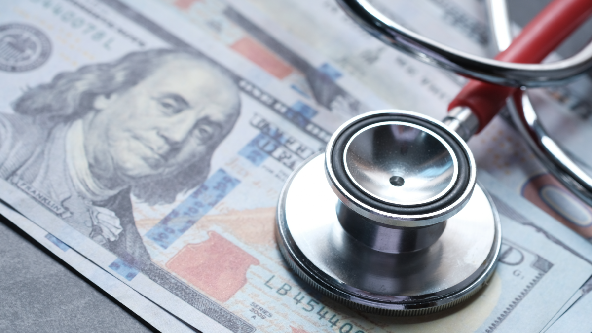 Health and Economic Costs a stethoscope on a pile of hundred dollar bills