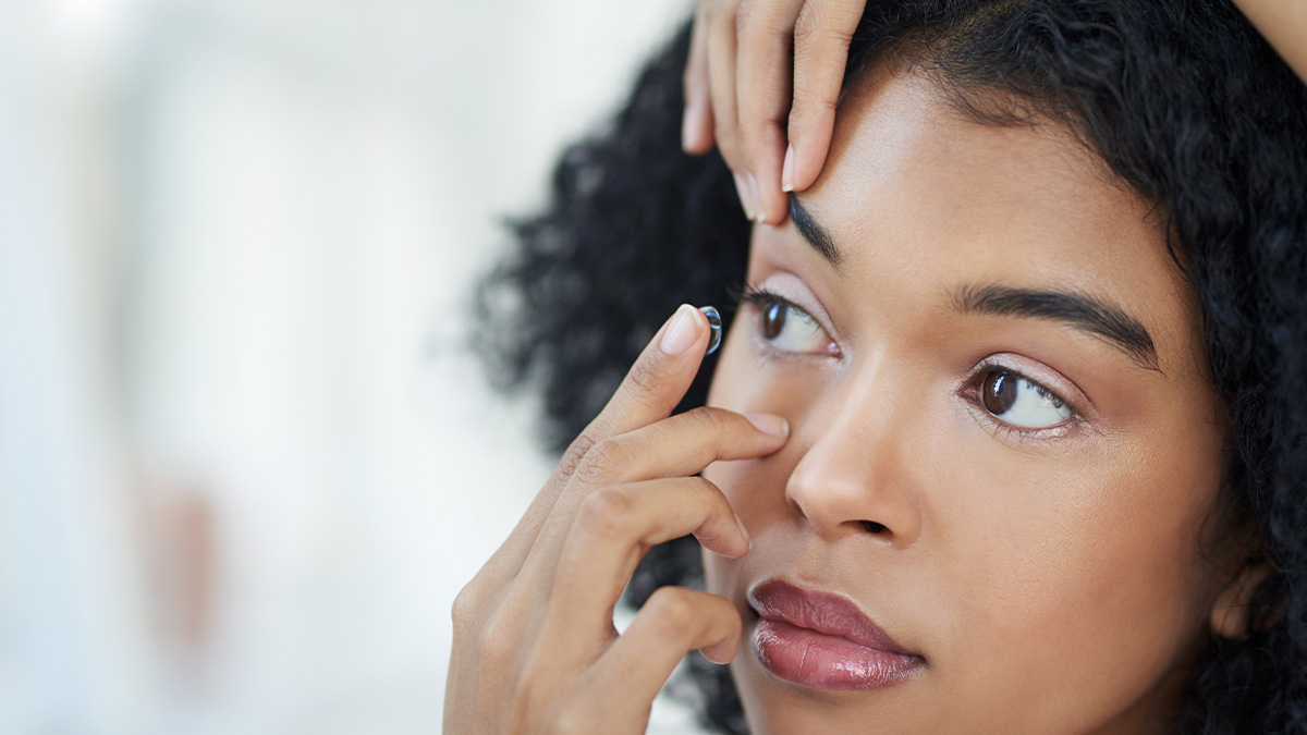 Woman putting on a contact lens