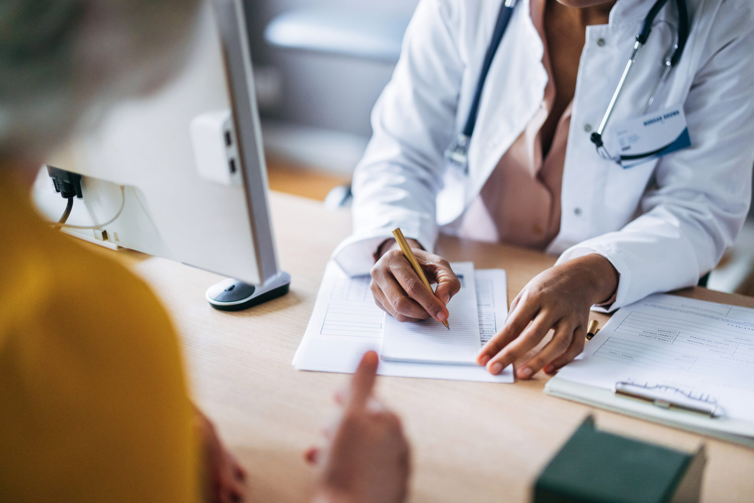 Healthcare provider writing a prescription.
