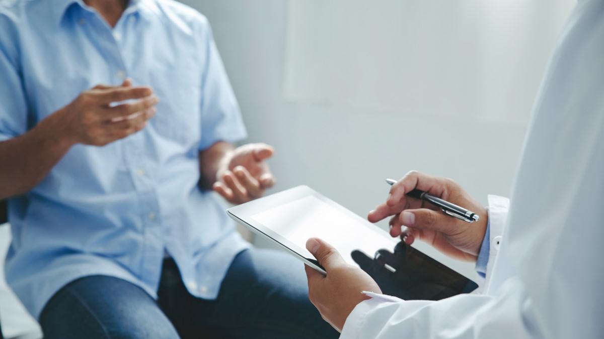 A healthcare provider talks with a patient.