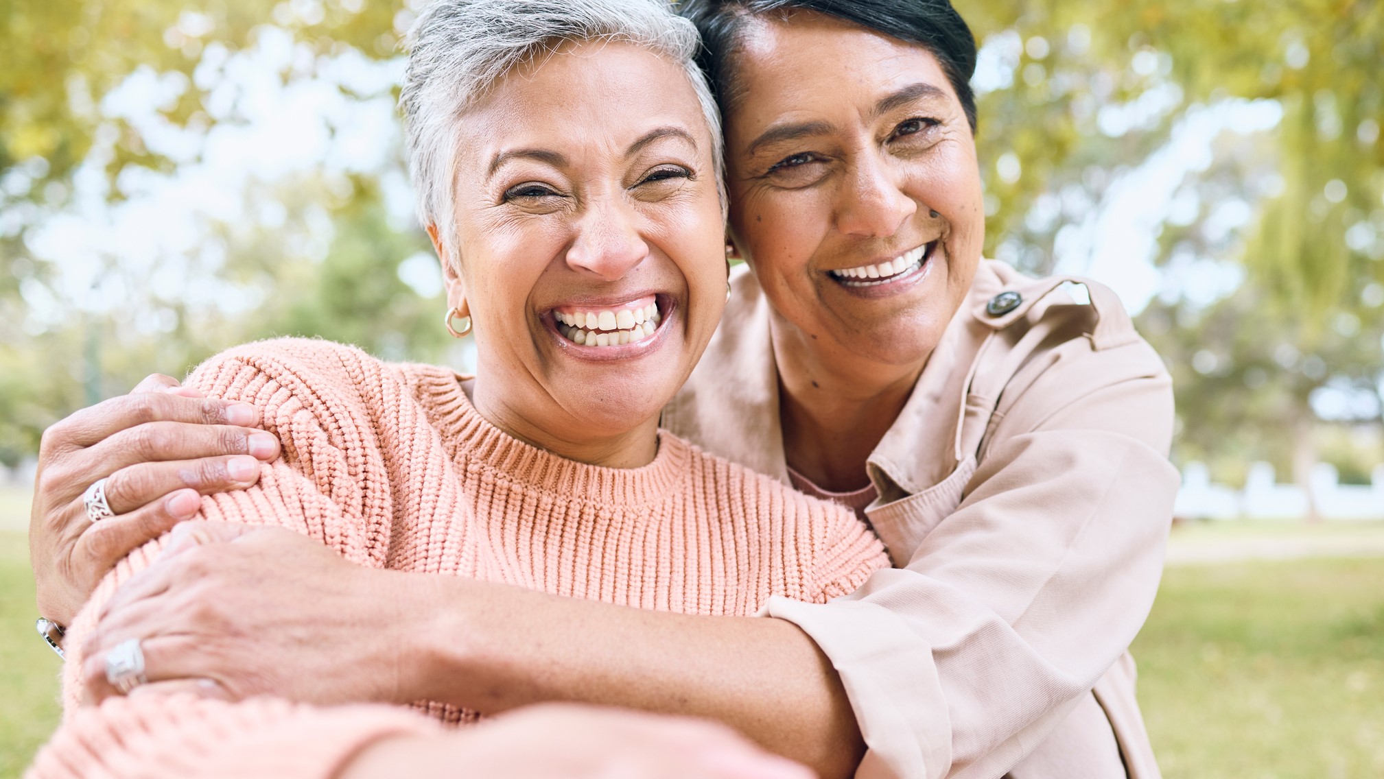 — title missing — Smiling happy older adult friends hugging