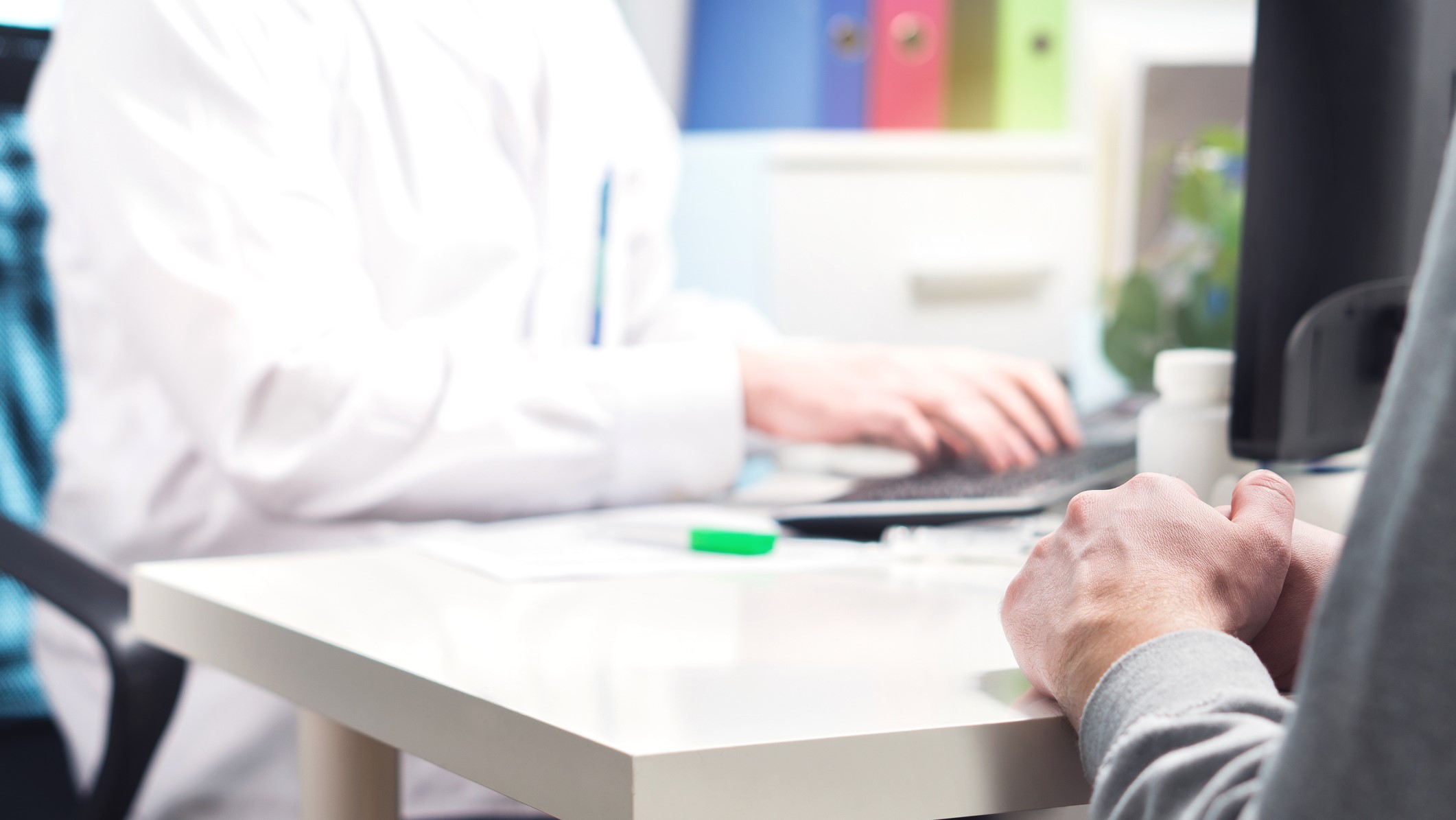— title missing — A health care professional updating an electronic health record for a patient