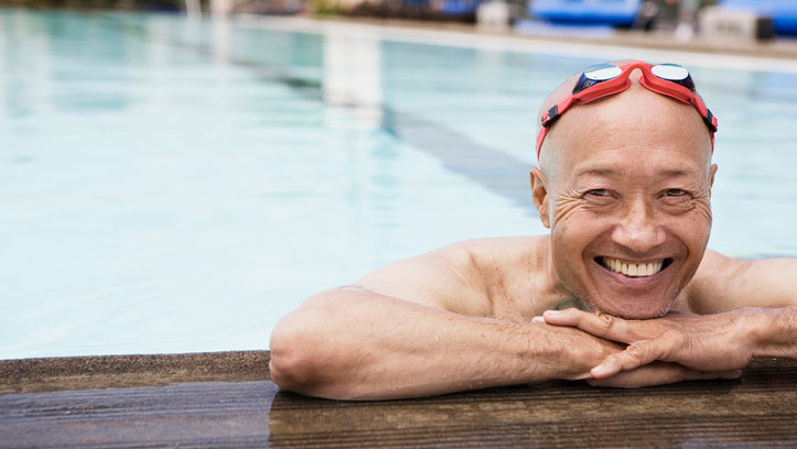 Smiling senior man swimmer wearing goggles Smiling senior man swimmer wearing goggles