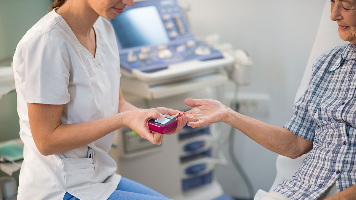 Diabetes Test Nurse giving an elderly patient a diabetes test