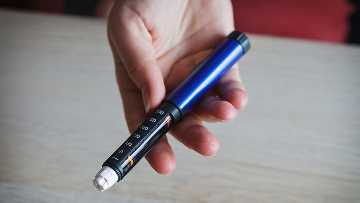 Woman holding pen injector woman holding insulin pen