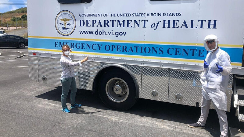EIS Officer and supervisor get ready in front of a mobile Emergency Operations Center in the U.S. Virgin Islands.