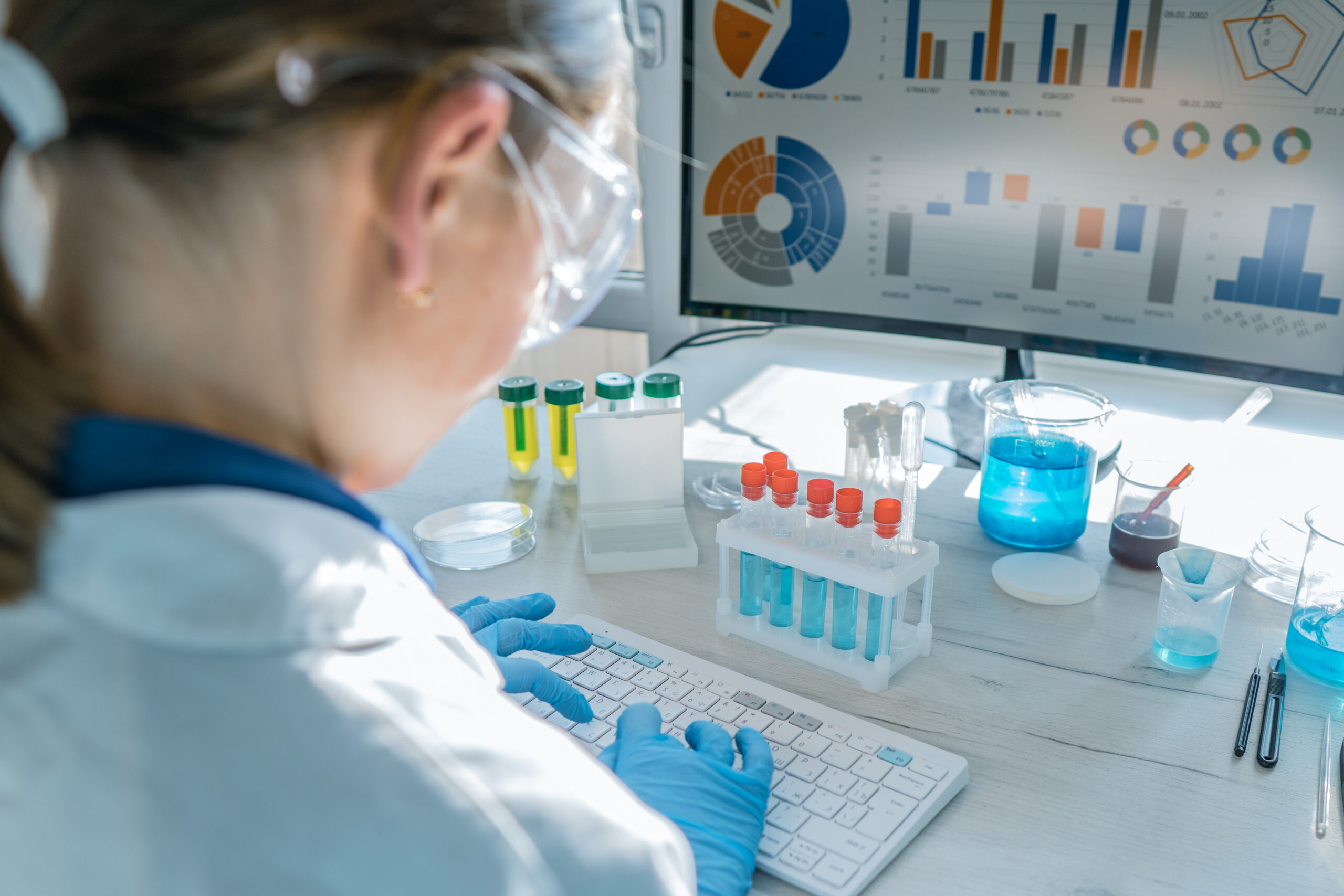 Researcher analyzes the results of experiments on a computer in laboratory.