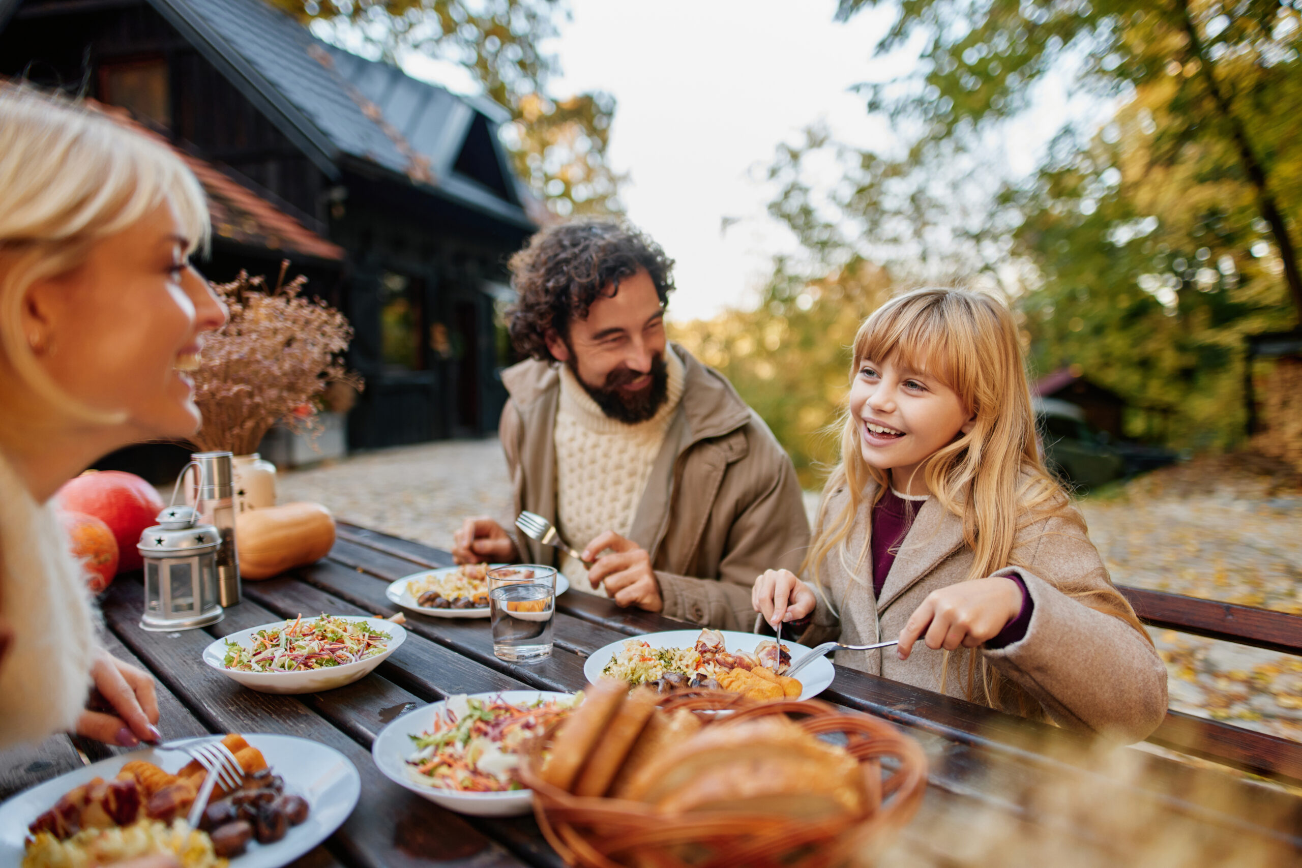 Family eating outdoors in fall