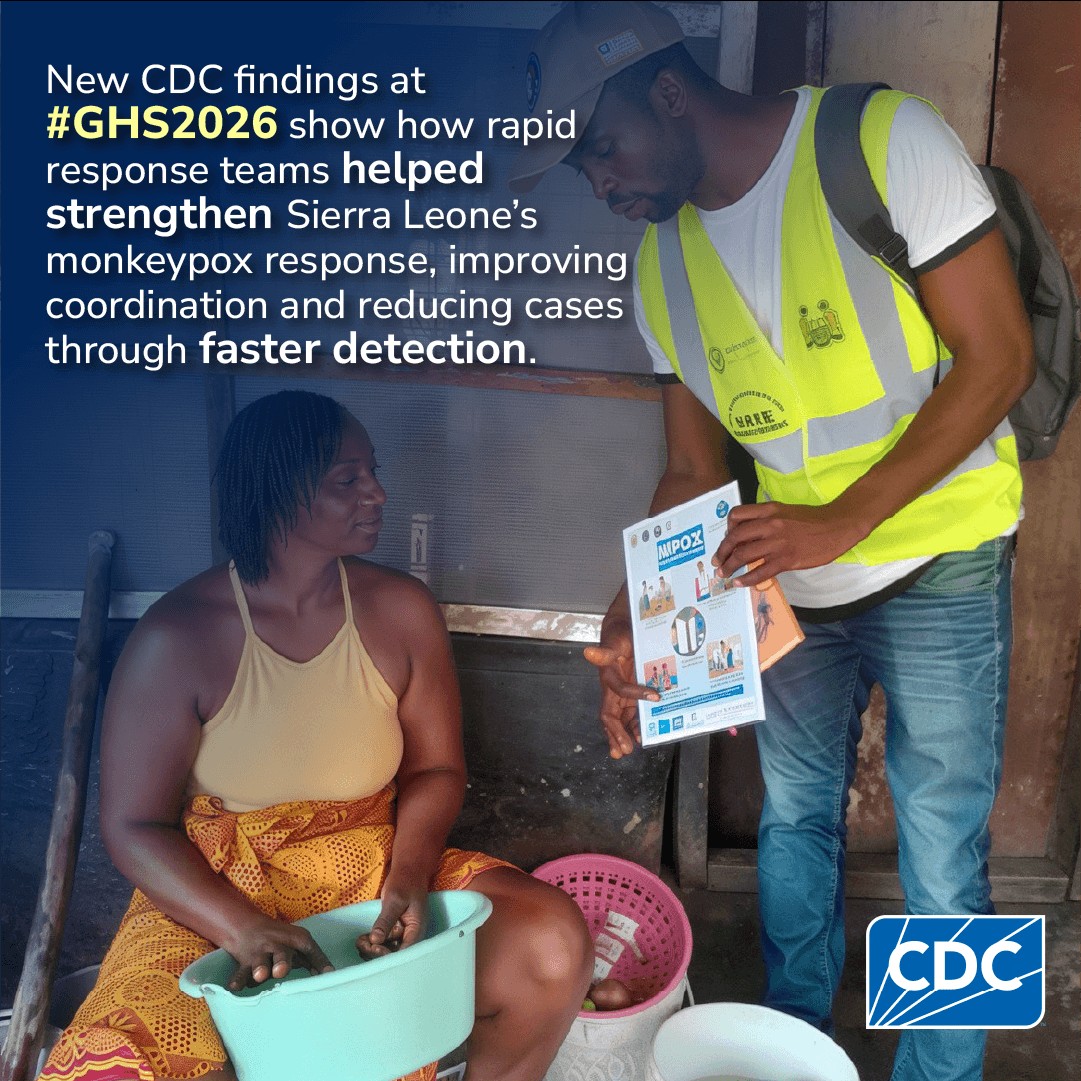 a worker teaching someone how to properly wash their hands to help prevent the spread of disease