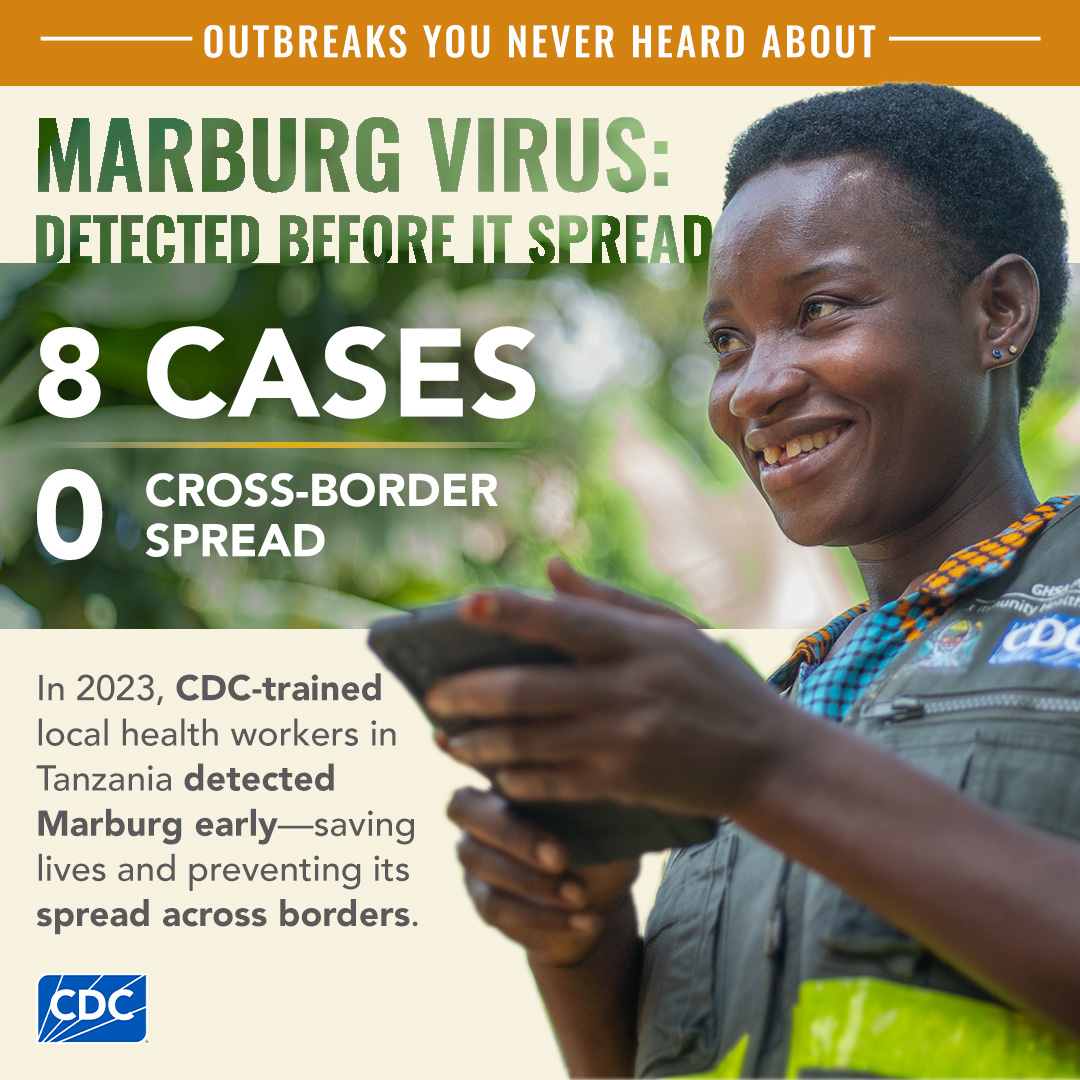 A woman smiling holding a tablet and wearing a CDC vest.
