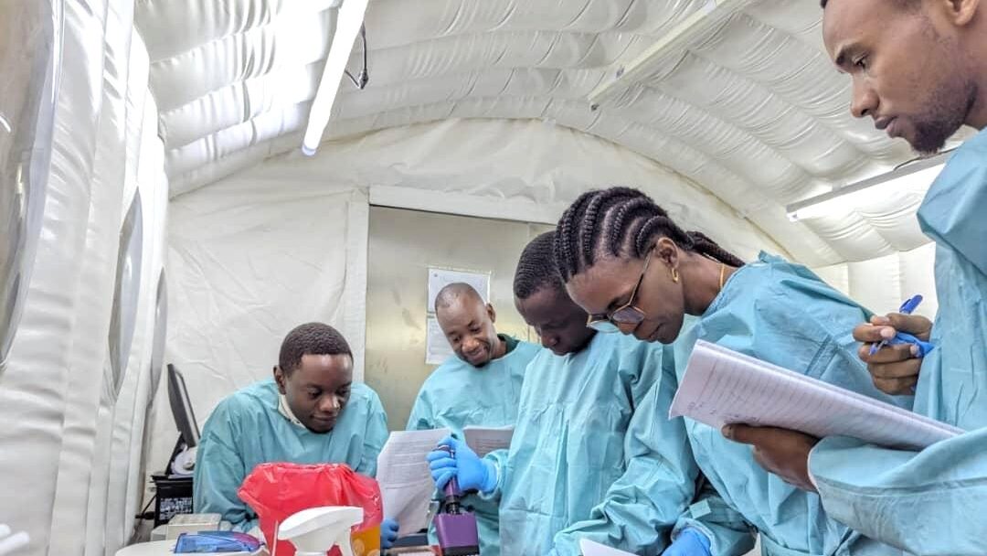 laboratory staff from the National Public Health Laboratory (NPHL) testing samples.