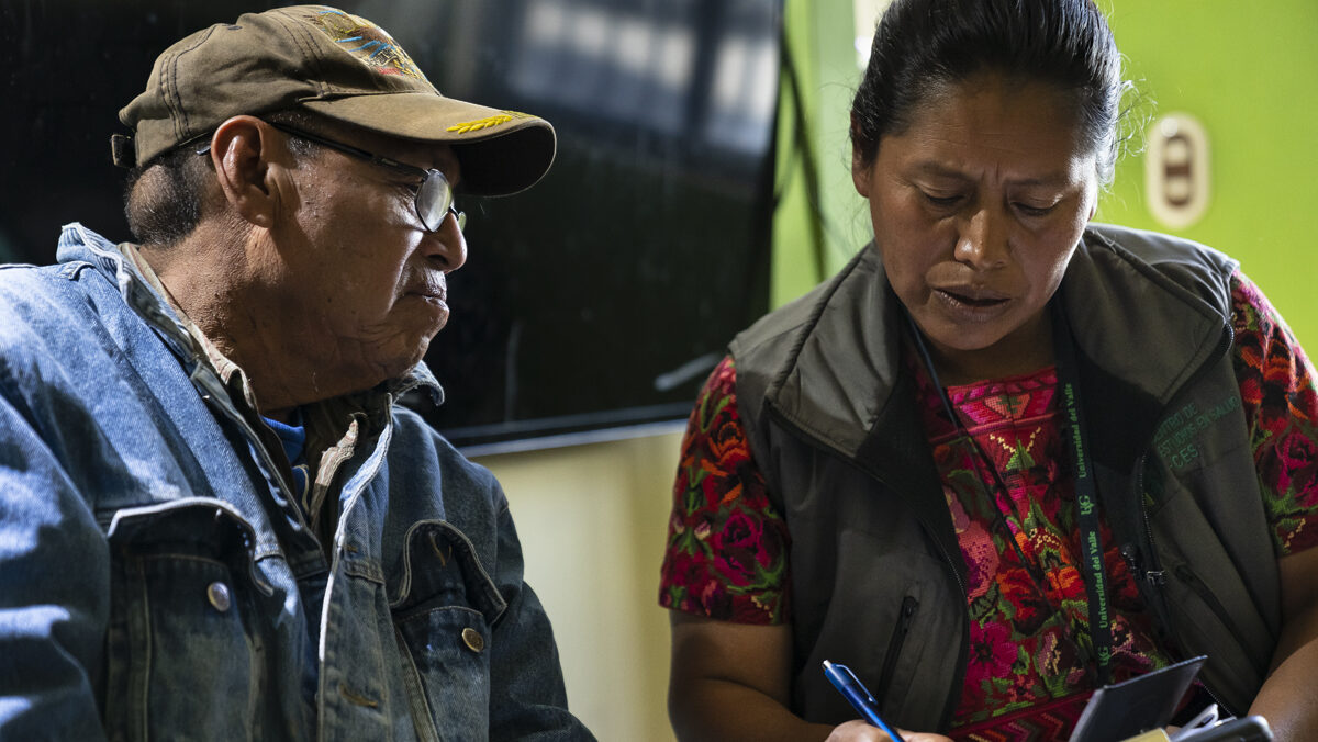 A field researcher conducts a household interview
