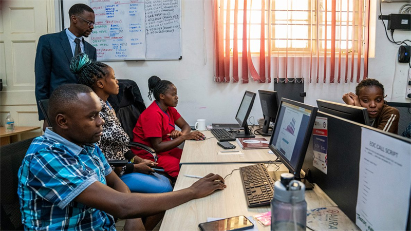 A group of people in the emergency operations center working in front of computers.