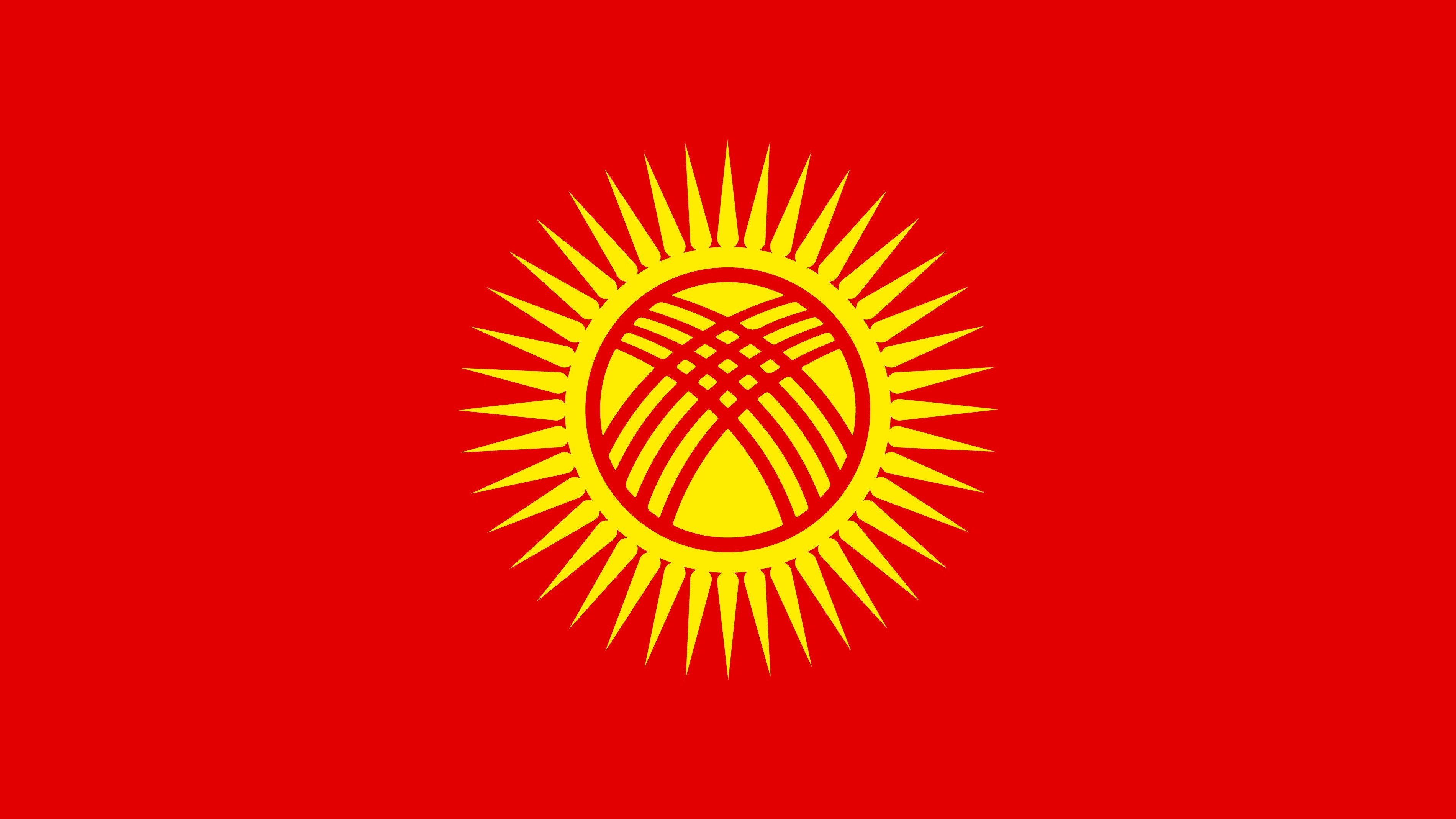 Flag of the Kyrgyz Republic with a sun and tunduk emblem centered on the field.