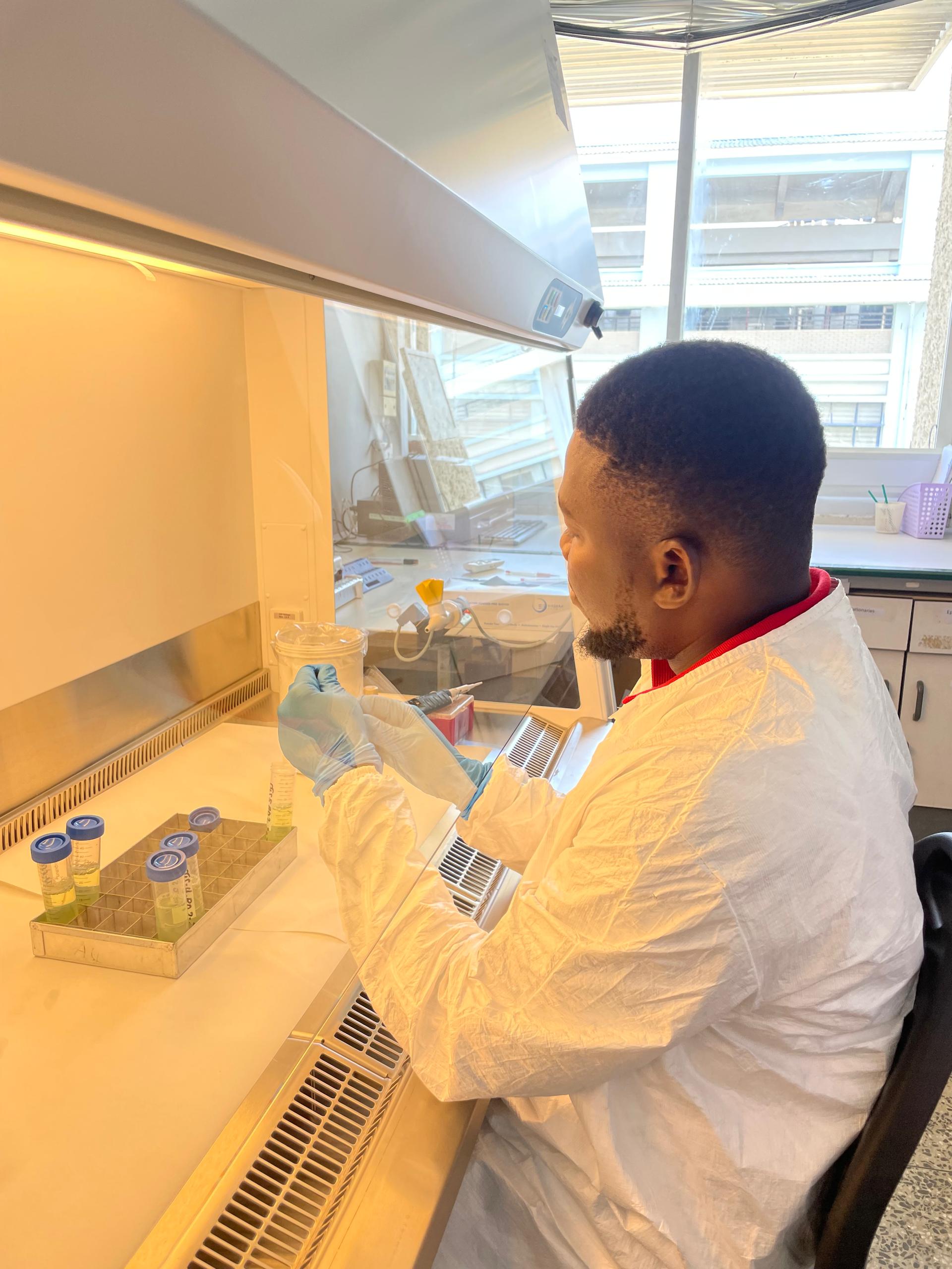 lab scientist in white labeling tubes.