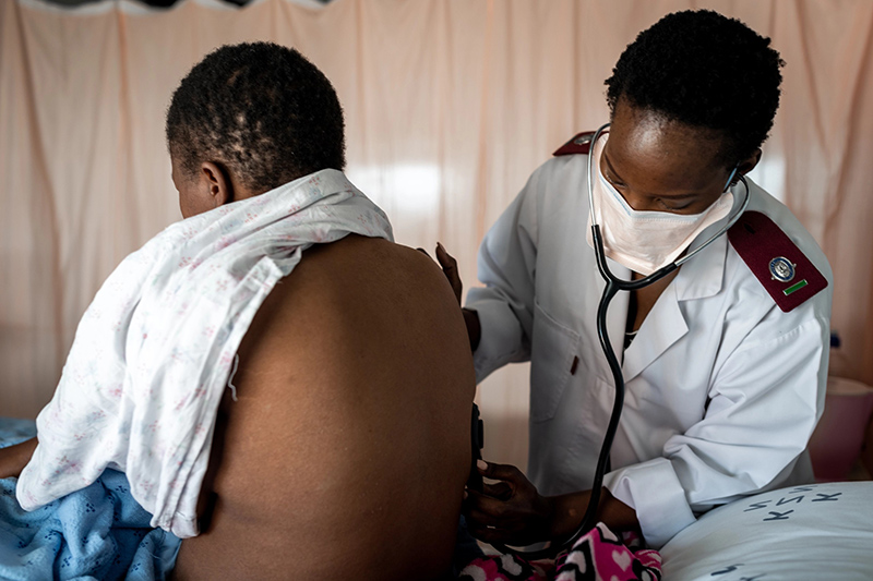 Healthcare provider assessing patient in medical setting