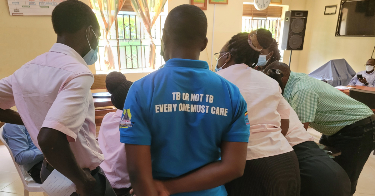 Health workers gather during a tuberculosis program visit.