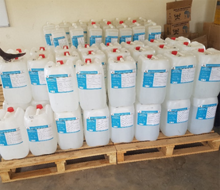 Containers full of alcohol-based hand sanitizer on a pallet ready for distribution.