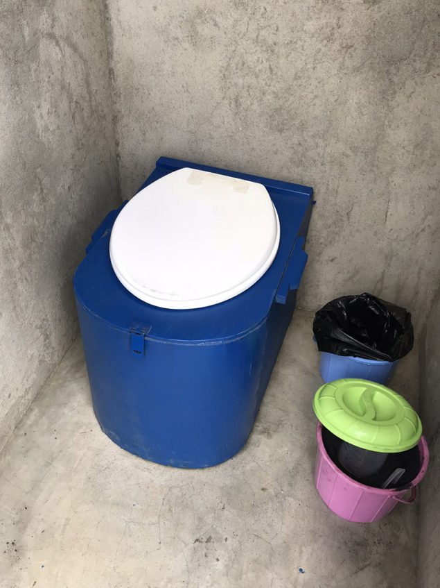 A large container-based toilet and two smaller containers