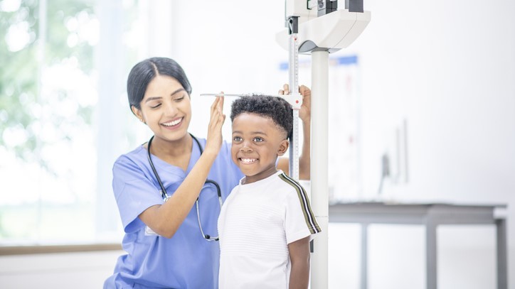 Boy on scales Nurse measuring a boy's height.