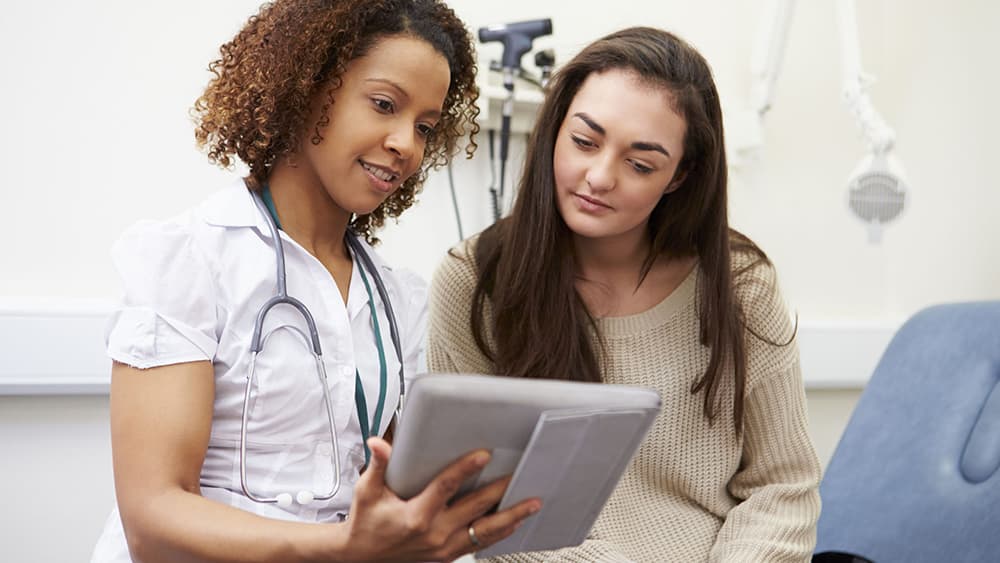 Female teen with a health care provider.