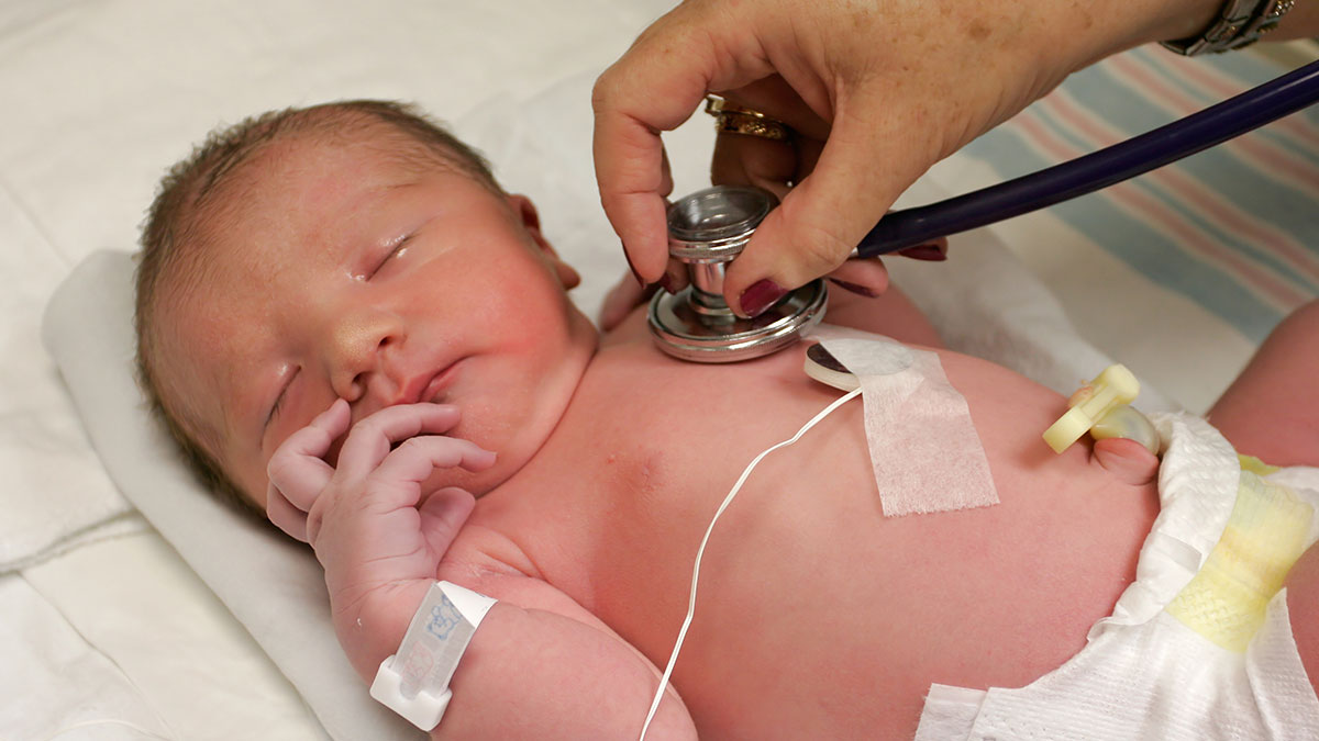 Doctor listening to baby's heart.