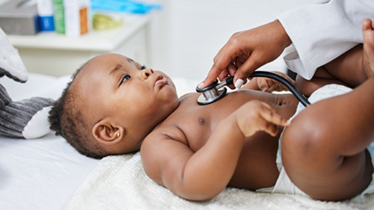 Doctor listening to infant's heart