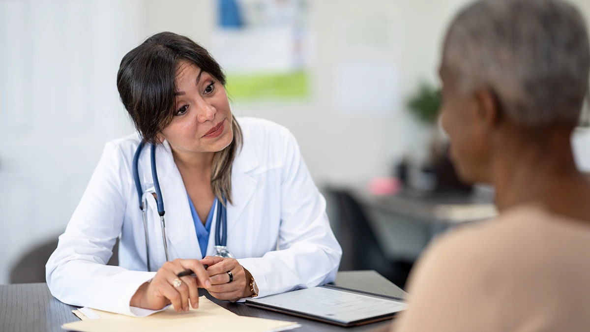Physician speaking with a female patient.