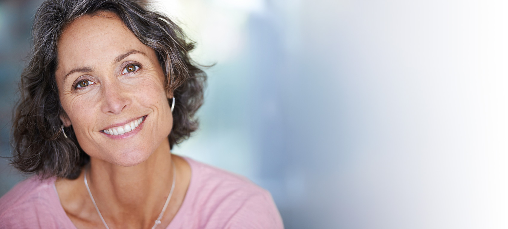 Woman in a pink shirt smiling