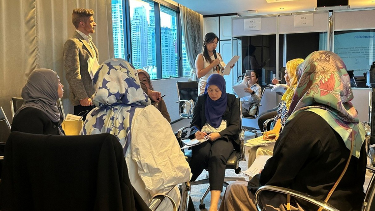 A room full of attendees working on an exercise together at the Thailand Regional Workshop