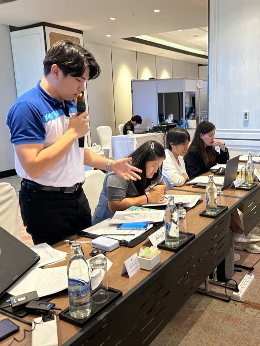 A participant speaks to the group in an exercise at the Thailand Regional Workshop