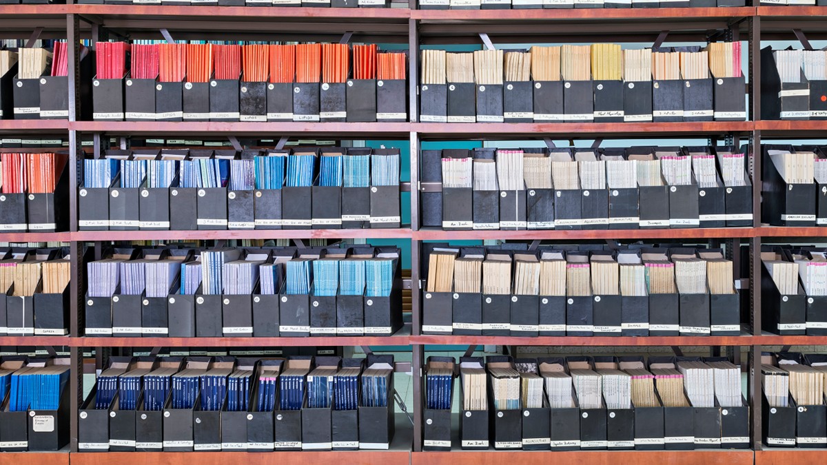 Shelves in a library containing reports.
