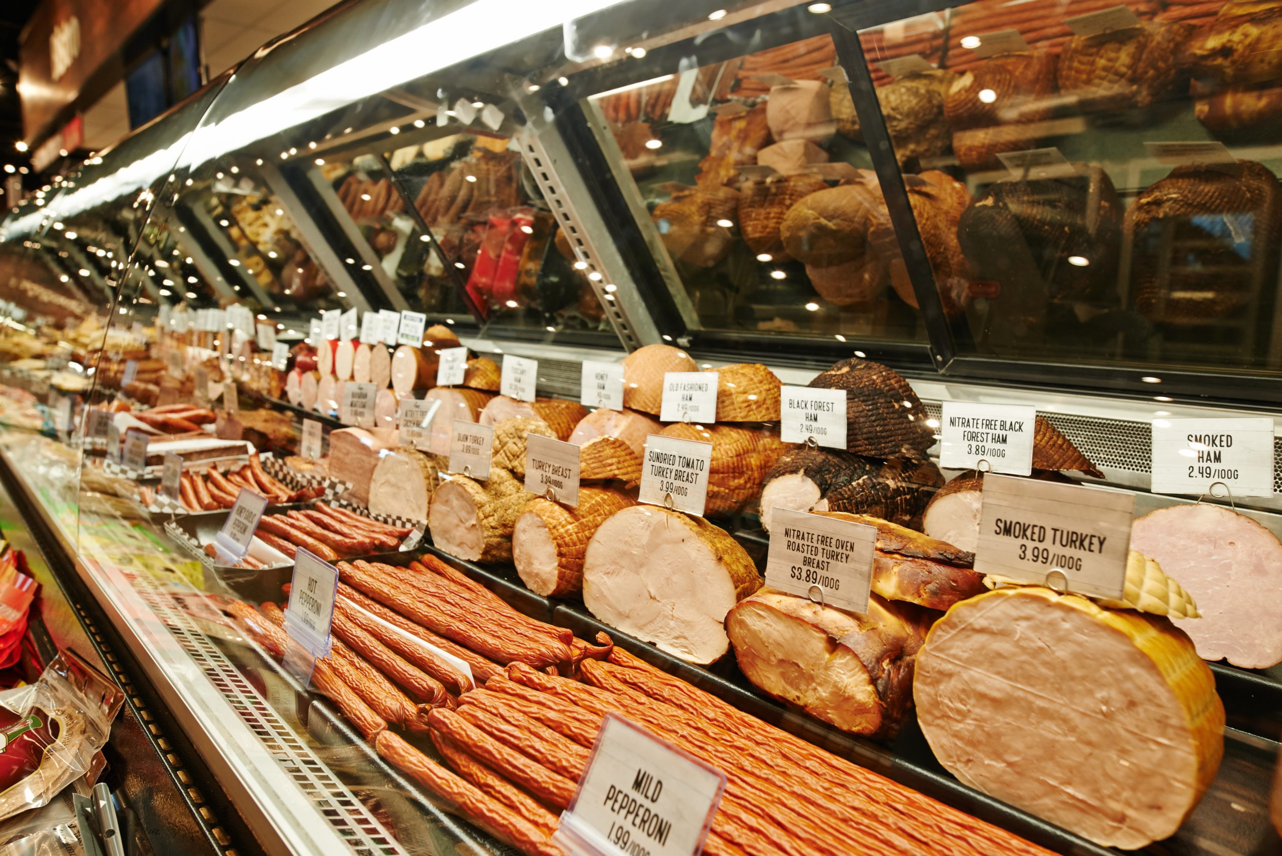 Deli Meat A deli market depicting different types of deli meat on display for slicing.