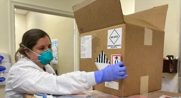 An LLS officer examines a box of hazardous material.