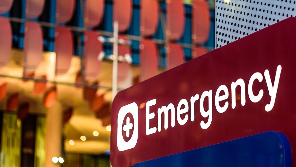A lit emergency department sign at a hospital