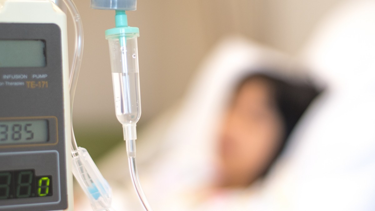 A patient receives IV medication in a hospital.