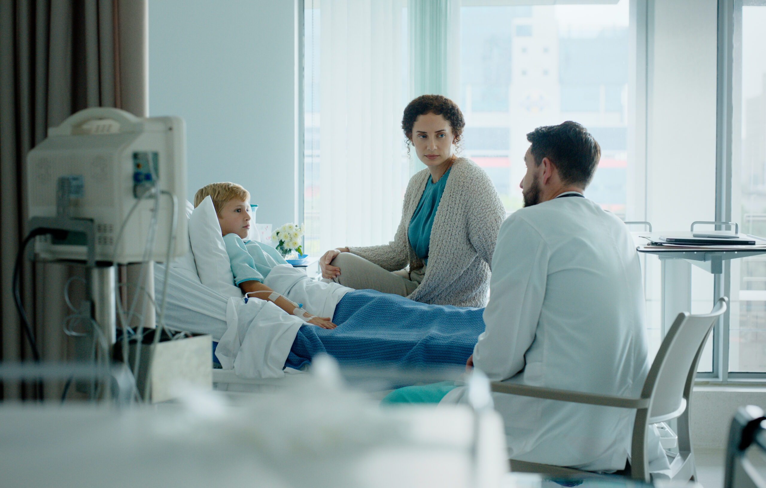 Image of doctor, parent and child in hospital